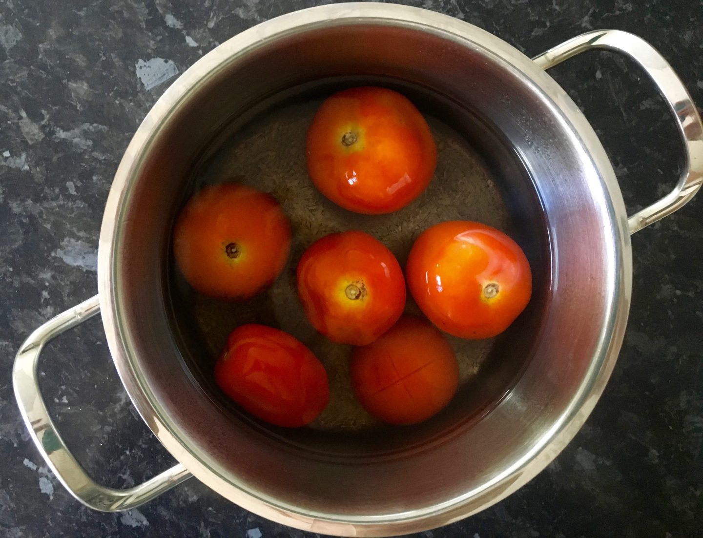 Using hot water to peel tomatoes