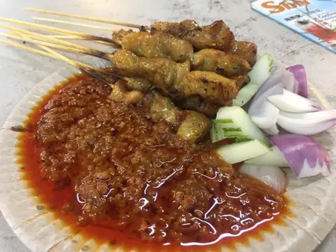 Satay in Penang with traditional cucumber and onion on the side