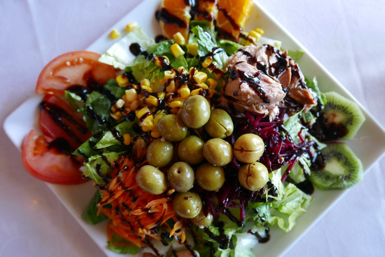 A piled high salad with olives, tuna, sweetcorn and tomatoes at Bodega Quatro Vientos