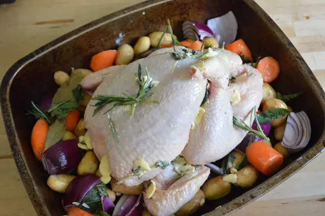 Chicken on a bed of vegetables. Ready for the oven.