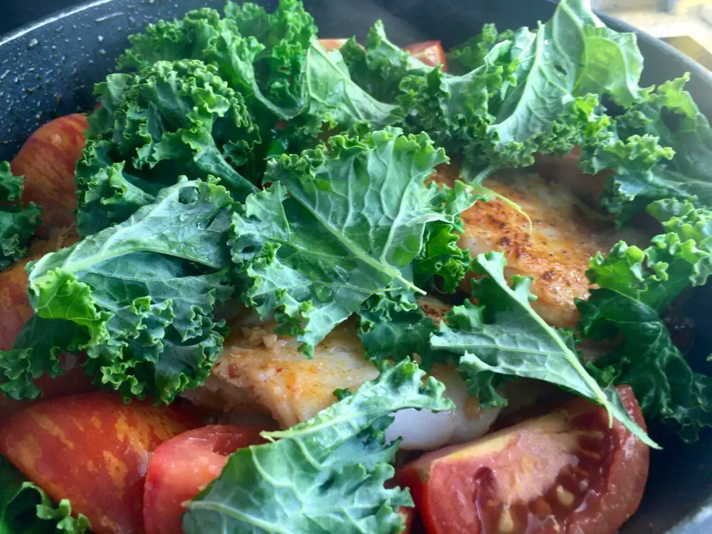 Kale with cod and tomatoes