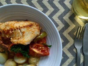 Cod with tomatoes, kale and chorizo