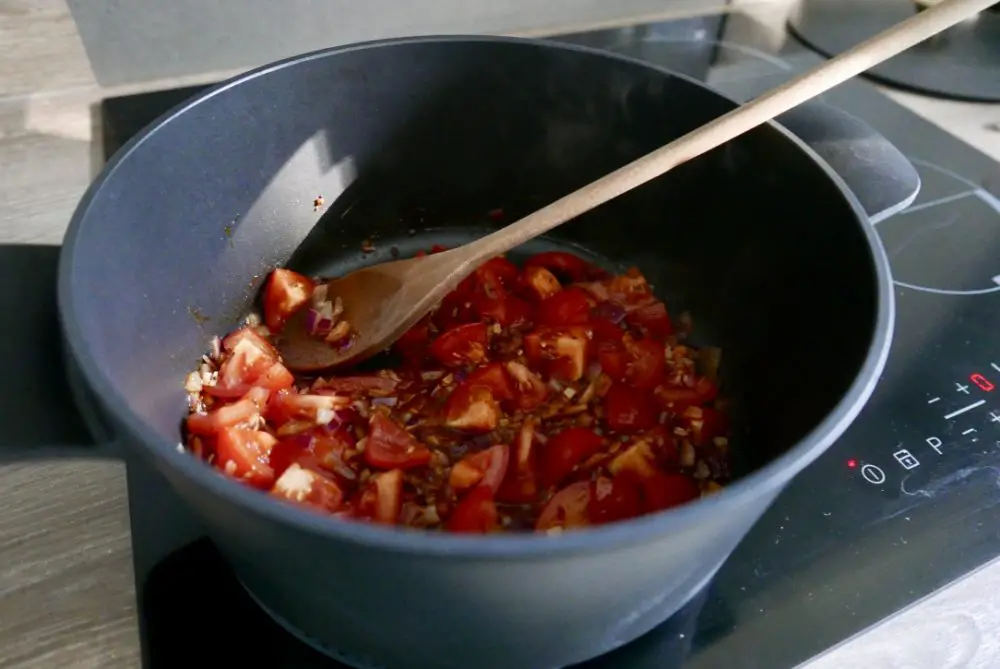 Simmering tomatoes for aubergine curry