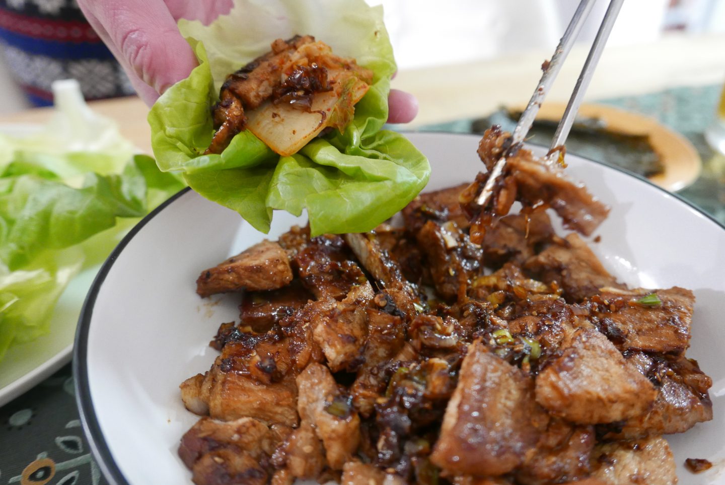 Wrapping the Korean BBQ Pork in lettuce leaves