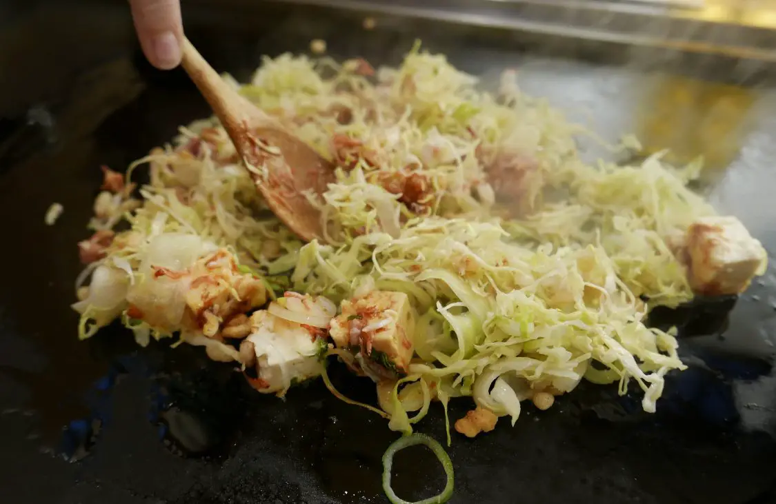 Frying monjayaki on a hot plate