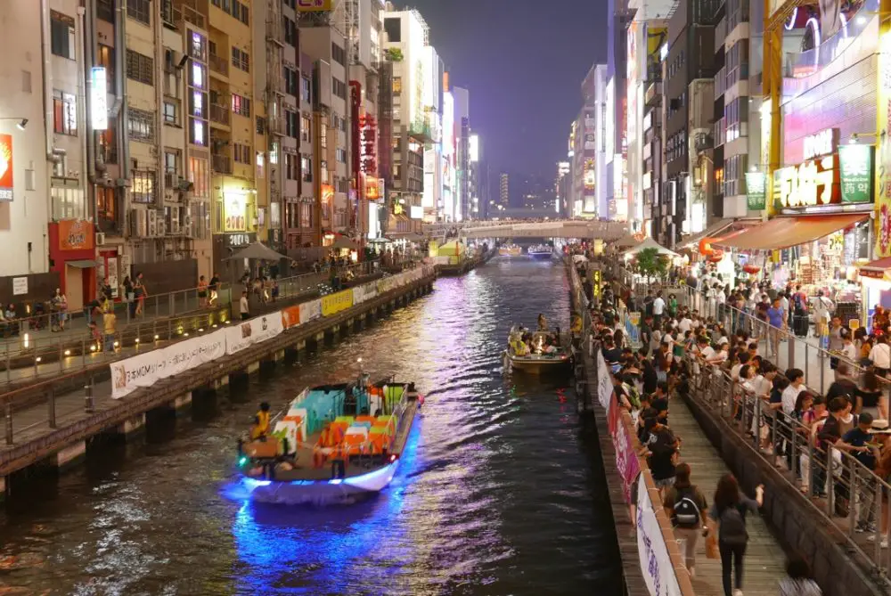 Dotonbori bridge in Osaka lit up at night.