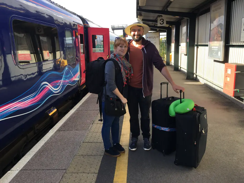 A couple ready for a travel adventure with suitcases