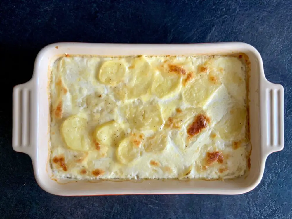 Scalloped potatoes browning under the grill