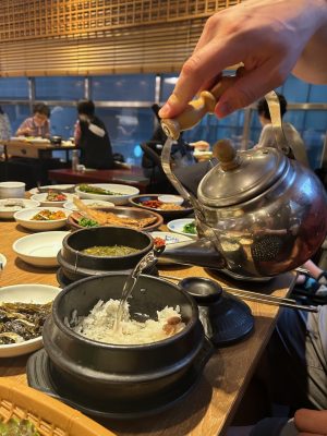 pouring water on the rice to make soup