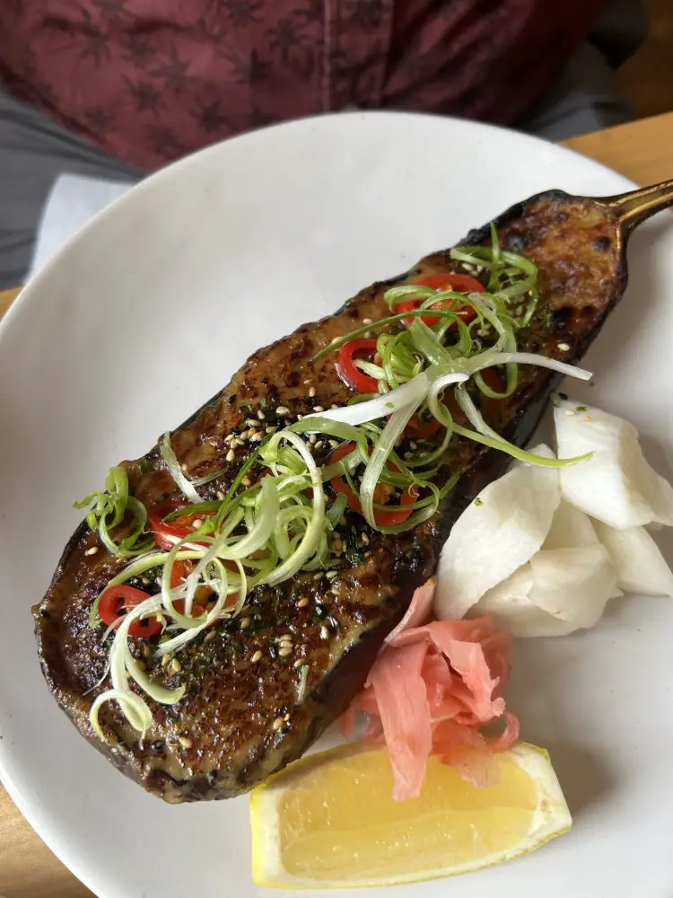 Miso butter aubergine topped with spring onion and red chilli