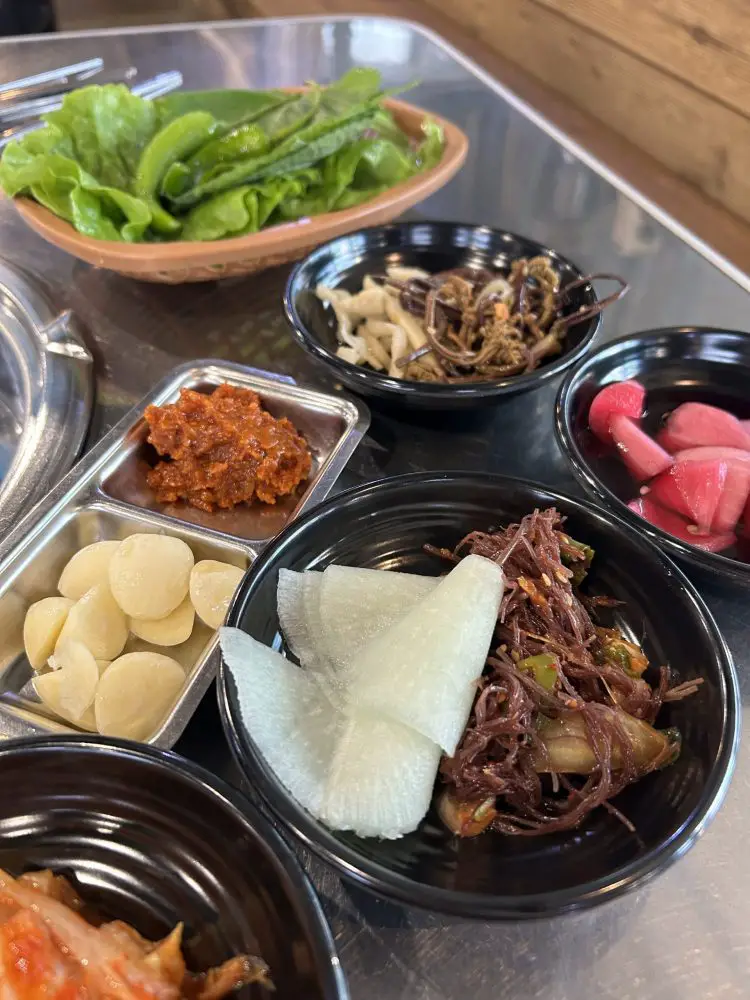 Banchan dishes served alongside KBBQ in Jeju