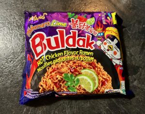 A purple and red packet of instant buldak habenero lime flavoured noodles