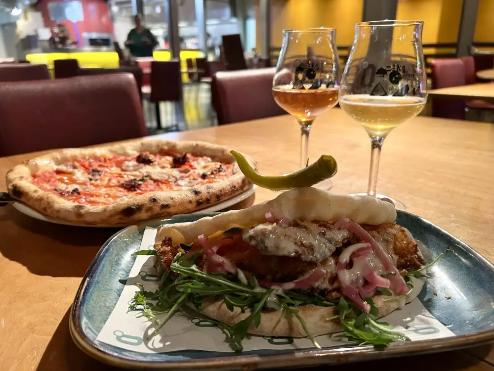 Pizza sandwich and pizza looking appetising on plates in a pub