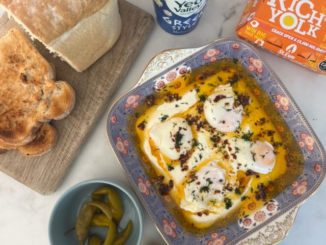 Turkish eggs photographed from above with chillis, toast and yoghurt