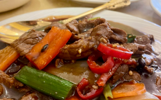 Beef in black bean sauce wih green, orange and red peppers