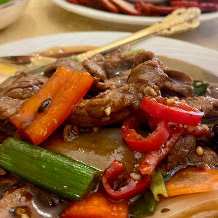 Beef in black bean sauce wih green, orange and red peppers